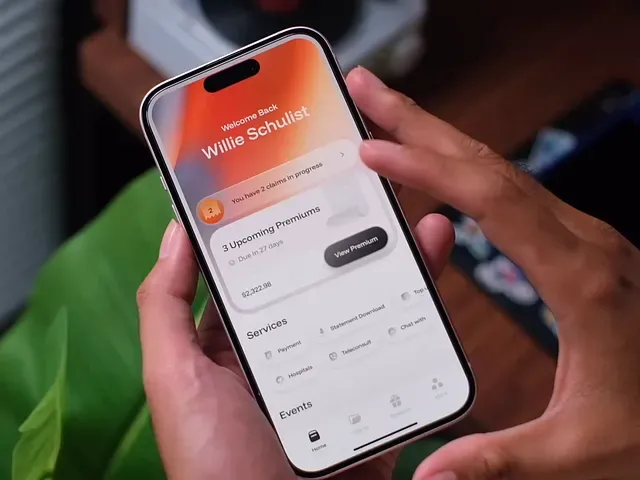A hand holding a phone against a warm dark background, running an app screen in amber and orange.
